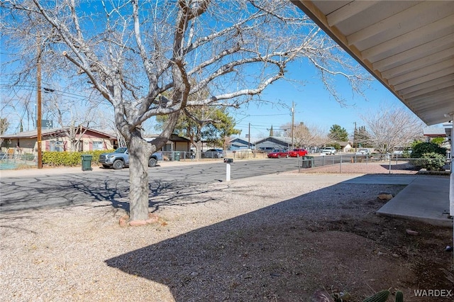 view of yard featuring a residential view and fence