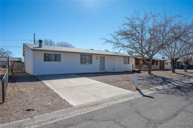 ranch-style house featuring fence