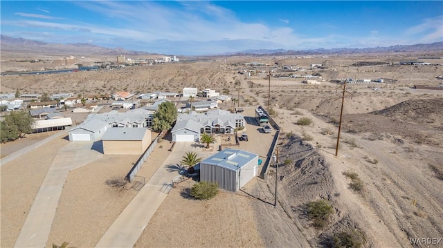 birds eye view of property featuring view of desert and a mountain view