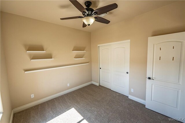 unfurnished bedroom with a closet, carpet flooring, a ceiling fan, and baseboards