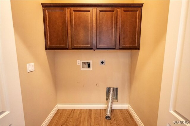 laundry area with hookup for a washing machine, cabinet space, light wood-style flooring, hookup for an electric dryer, and gas dryer hookup