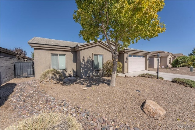 ranch-style home featuring fence, driveway, an attached garage, and stucco siding