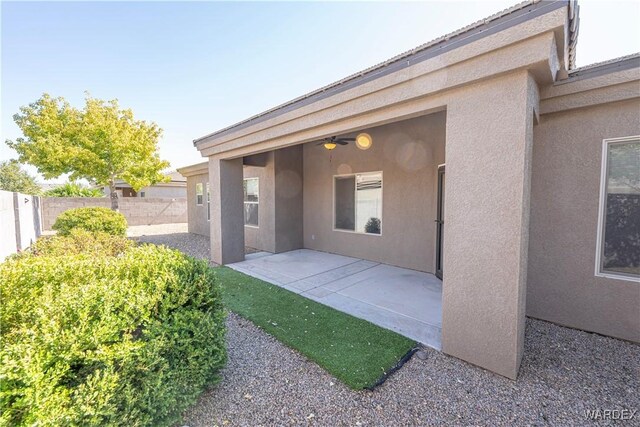 exterior space featuring a patio area, a fenced backyard, and stucco siding