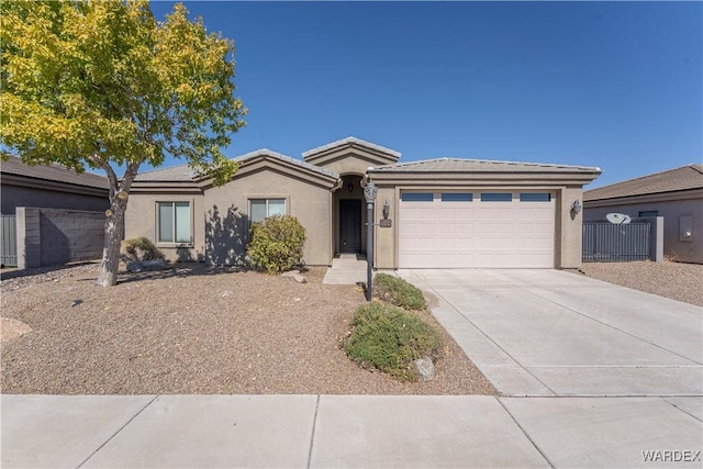 ranch-style home featuring driveway, an attached garage, fence, and stucco siding