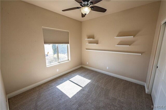 unfurnished room with ceiling fan, carpet flooring, and baseboards