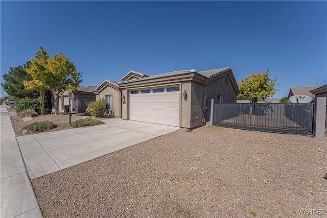 view of front facade with an attached garage, fence, concrete driveway, and stucco siding