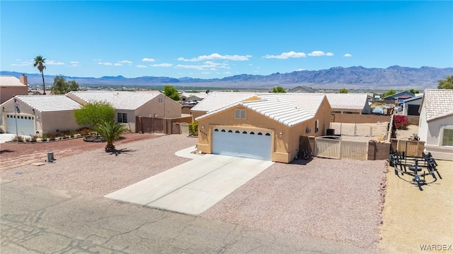 4403 S Via Rialto Ln, Fort Mohave, AZ 86426 - ranch-style home with a garage, fence, a mountain view, and a tiled roof