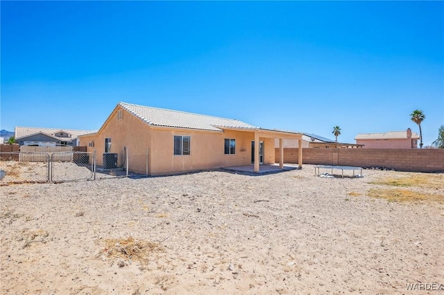 4403 S Via Rialto Ln, Fort Mohave, AZ 86426 - rear view of house featuring stucco siding, a fenced backyard, a gate, a patio, and a tiled roof