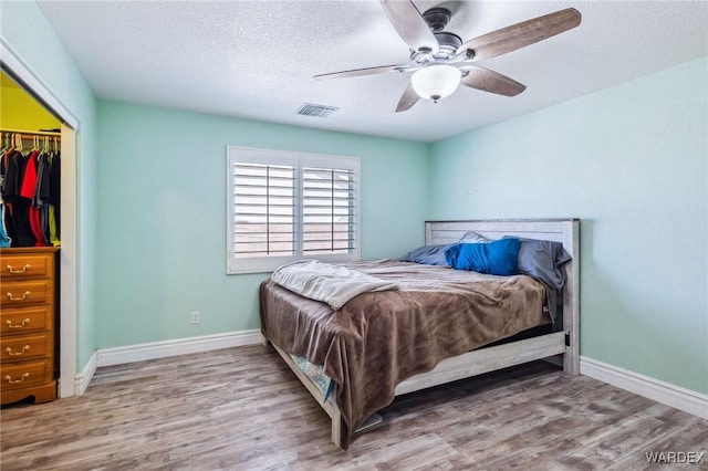 4403 S Via Rialto Ln, Fort Mohave, AZ 86426 - bedroom featuring visible vents, a closet, wood finished floors, baseboards, and a textured ceiling