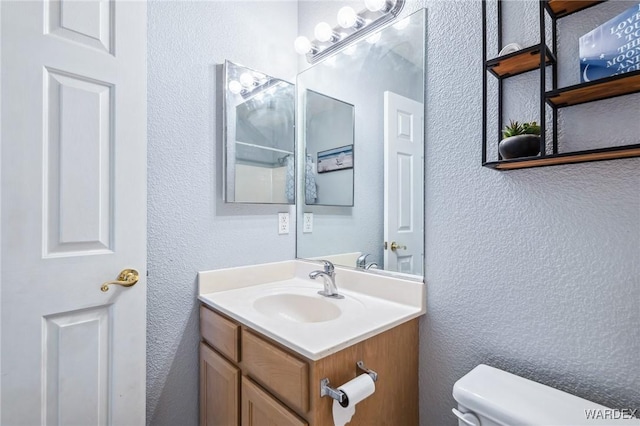 4403 S Via Rialto Ln, Fort Mohave, AZ 86426 - bathroom with vanity, a textured wall, and toilet