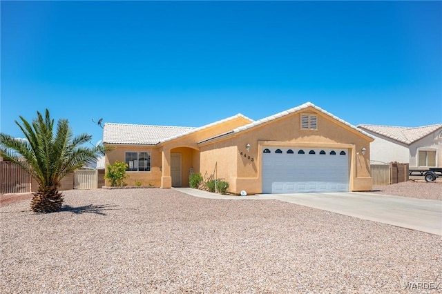 4403 S Via Rialto Ln, Fort Mohave, AZ 86426 - ranch-style house with fence, a tile roof, a garage, stucco siding, and driveway