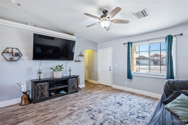 4403 S Via Rialto Ln, Fort Mohave, AZ 86426 - living area featuring a ceiling fan, visible vents, arched walkways, wood finished floors, and baseboards