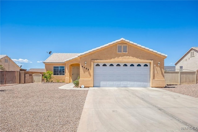 4403 S Via Rialto Ln, Fort Mohave, AZ 86426 - ranch-style home with fence, stucco siding, driveway, and a garage
