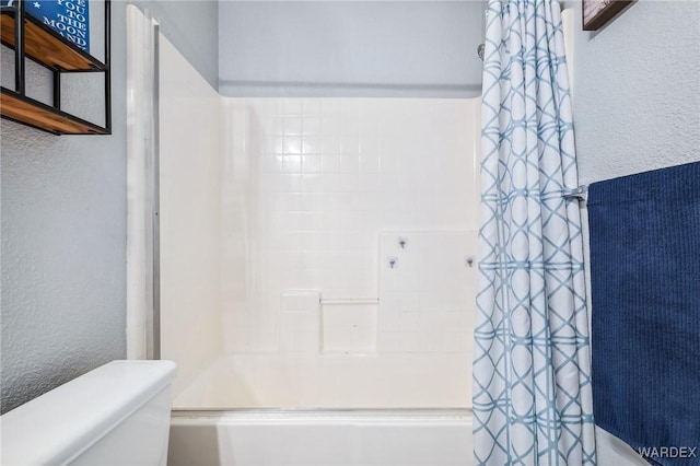 4403 S Via Rialto Ln, Fort Mohave, AZ 86426 - bathroom with shower / bath combo with shower curtain, a textured wall, and toilet