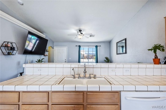 4403 S Via Rialto Ln, Fort Mohave, AZ 86426 - kitchen featuring white dishwasher, a ceiling fan, tile countertops, and a sink