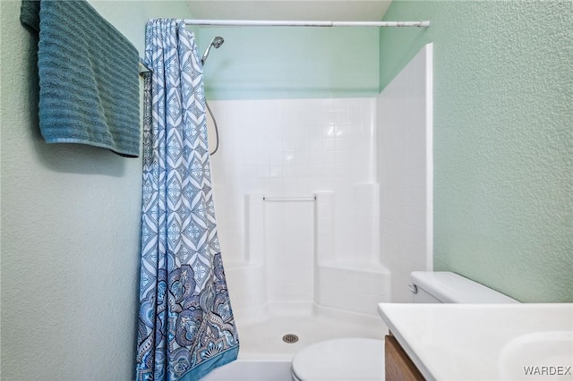 4403 S Via Rialto Ln, Fort Mohave, AZ 86426 - bathroom featuring vanity, a textured wall, toilet, and a shower stall