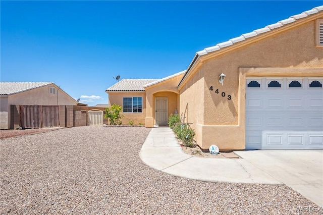 4403 S Via Rialto Ln, Fort Mohave, AZ 86426 - ranch-style home with fence, a gate, a tile roof, and stucco siding
