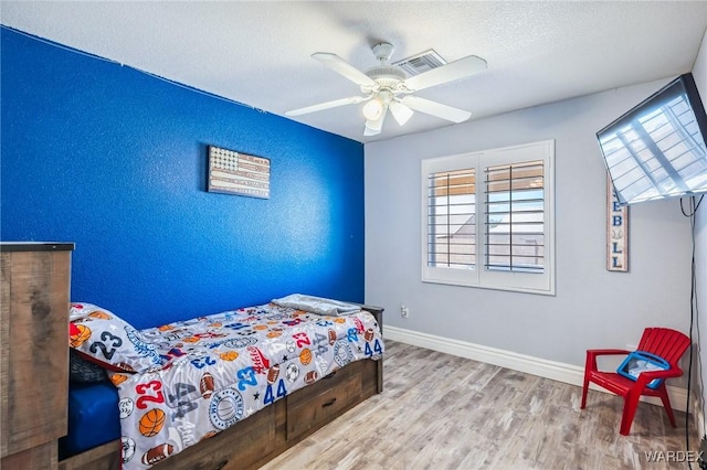 4403 S Via Rialto Ln, Fort Mohave, AZ 86426 - bedroom with a textured ceiling, a ceiling fan, baseboards, wood finished floors, and visible vents