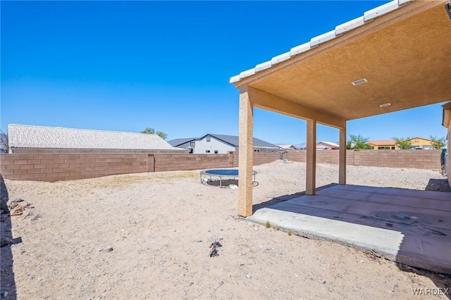 4403 S Via Rialto Ln, Fort Mohave, AZ 86426 - view of yard with a fenced backyard, a trampoline, and a patio
