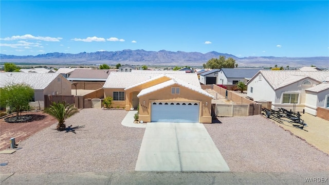 4403 S Via Rialto Ln, Fort Mohave, AZ 86426 - view of front of house featuring fence, an attached garage, concrete driveway, and a residential view