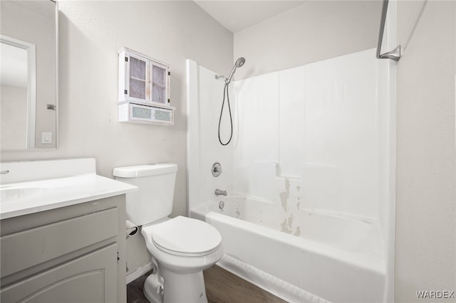 full bath featuring shower / bathing tub combination, vanity, toilet, and wood finished floors