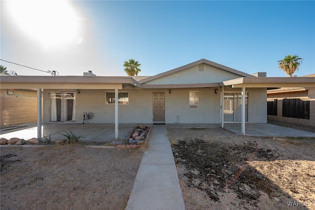 single story home featuring fence and stucco siding