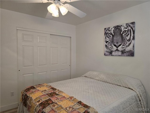 bedroom with a closet, baseboards, ceiling fan, and wood finished floors