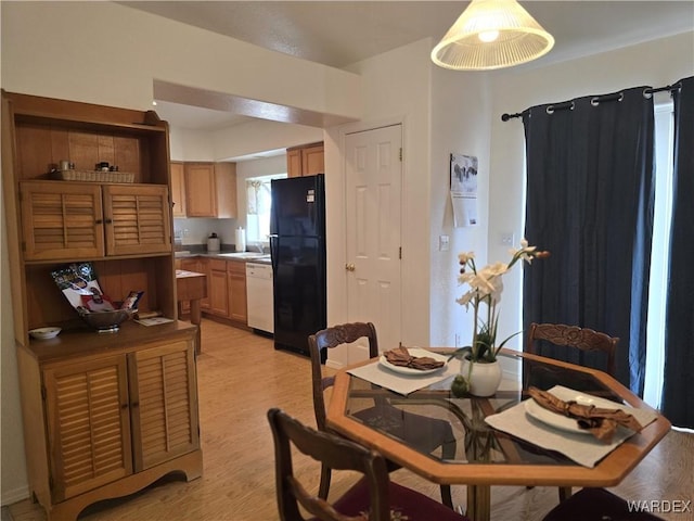 dining space with light wood-style floors