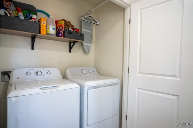 washroom featuring laundry area and separate washer and dryer