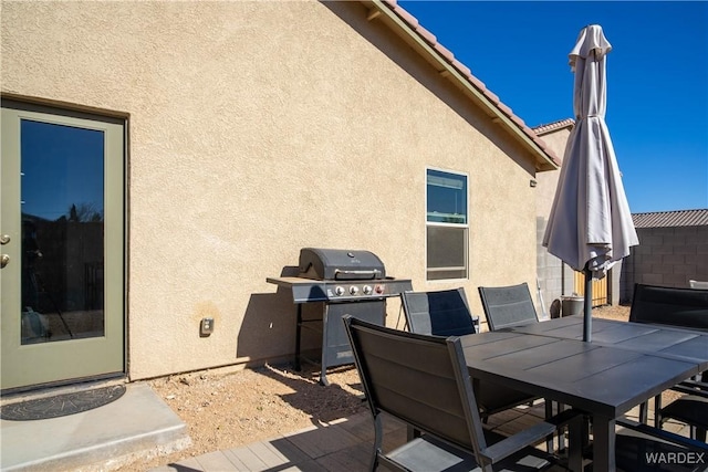 view of patio / terrace with outdoor dining area, fence, and grilling area