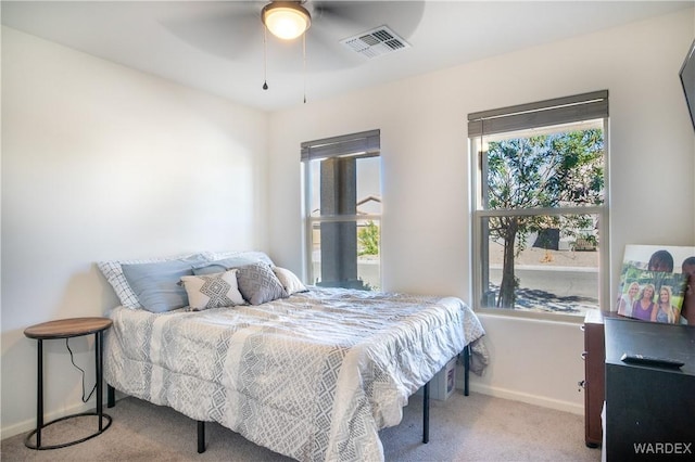 bedroom featuring baseboards, visible vents, ceiling fan, and light colored carpet