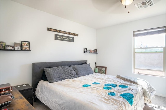 bedroom featuring carpet floors, visible vents, and ceiling fan