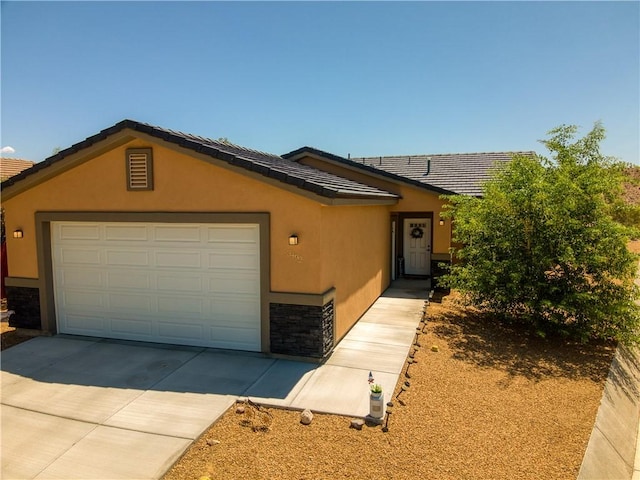3492 Tres Alamos Dr, Bullhead City, AZ 86442 - ranch-style house with stucco siding, driveway, an attached garage, and a tiled roof