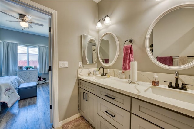 3492 Tres Alamos Dr, Bullhead City, AZ 86442 - ensuite bathroom featuring double vanity, ceiling fan, and wood finished floors
