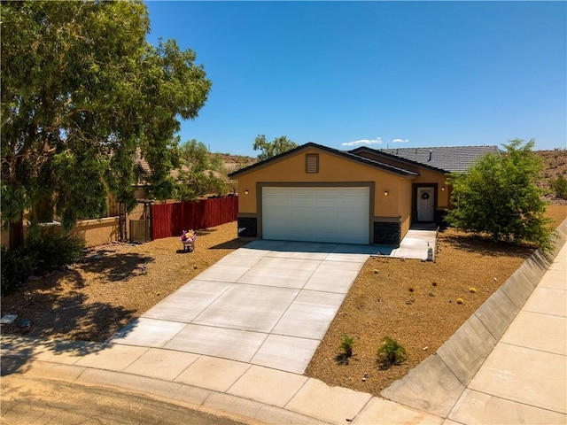 3492 Tres Alamos Dr, Bullhead City, AZ 86442 - ranch-style home featuring driveway, a garage, and stucco siding