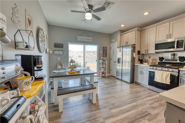 3492 Tres Alamos Dr, Bullhead City, AZ 86442 - kitchen featuring stainless steel appliances, light countertops, a ceiling fan, light wood finished floors, and recessed lighting