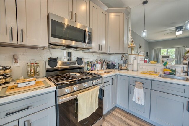 3492 Tres Alamos Dr, Bullhead City, AZ 86442 - kitchen featuring stainless steel appliances, light countertops, ceiling fan, and light wood finished floors