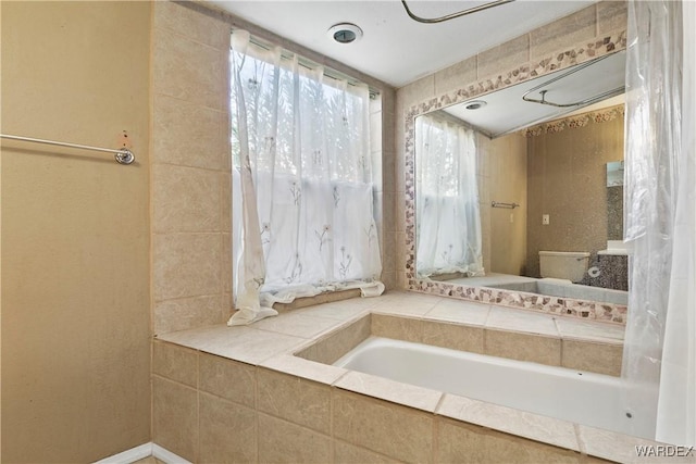 full bathroom featuring tiled bath