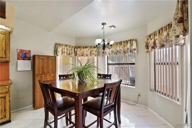 dining area featuring baseboards, visible vents, a notable chandelier, and light tile patterned flooring