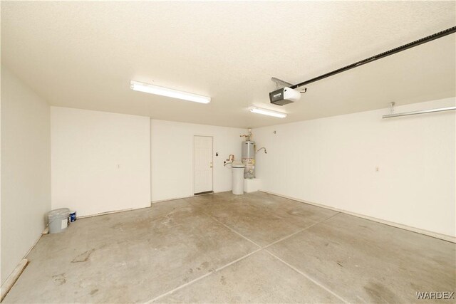 garage featuring gas water heater and a garage door opener