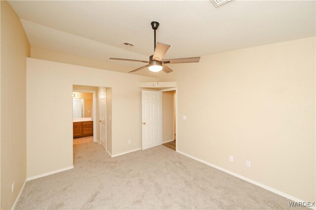 unfurnished bedroom with ensuite bathroom, light colored carpet, a ceiling fan, baseboards, and visible vents