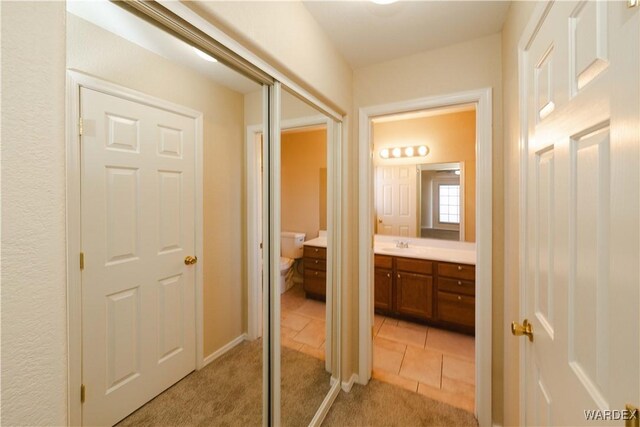 bathroom featuring toilet, tile patterned floors, and vanity