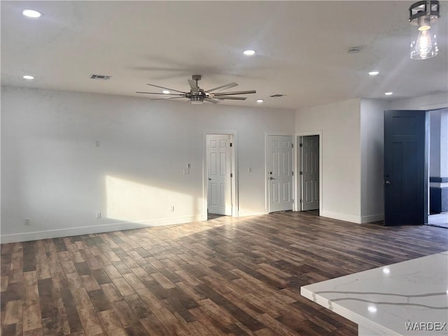 spare room featuring recessed lighting, dark wood-type flooring, a ceiling fan, baseboards, and visible vents