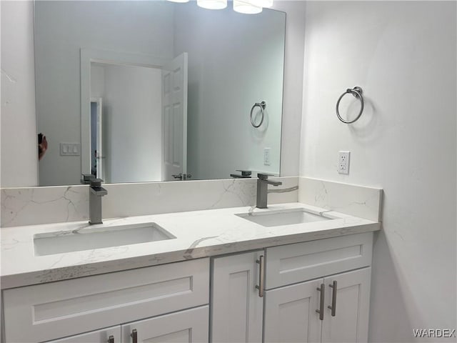 full bath with a sink and double vanity