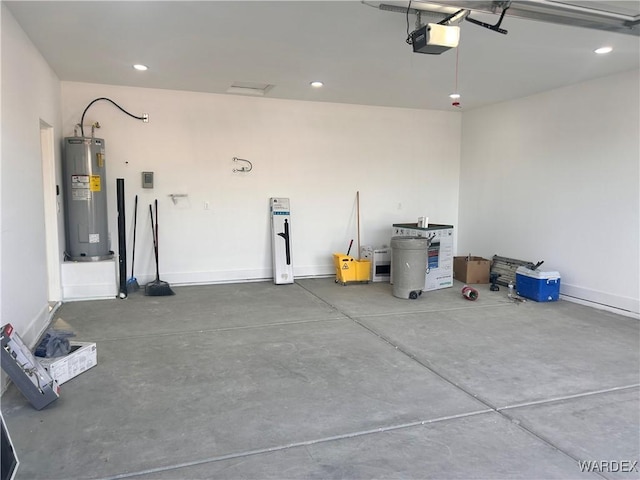 garage with a garage door opener, recessed lighting, water heater, and baseboards