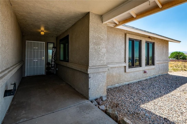 view of side of property featuring stucco siding