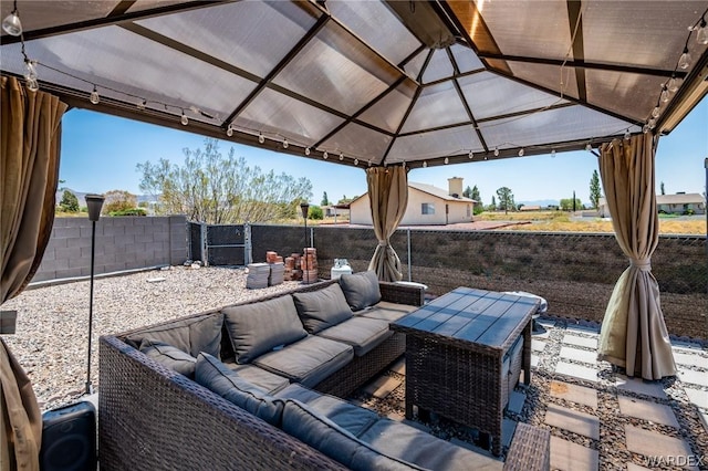 view of patio / terrace with a gazebo, a fenced backyard, and an outdoor living space