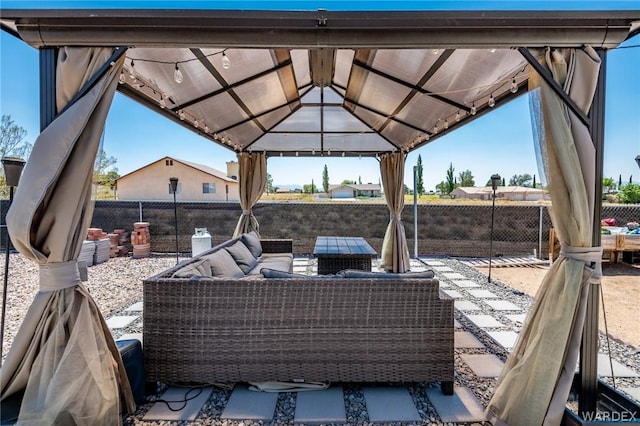 view of patio with a gazebo, outdoor lounge area, and fence