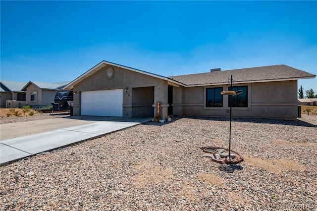 ranch-style house featuring an attached garage, concrete driveway, and stucco siding