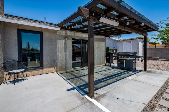 view of patio featuring a pergola, fence, and a grill